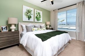 Palm Desert apartment for rent - A bedroom with a large bed and two framed pictures on the wall.
