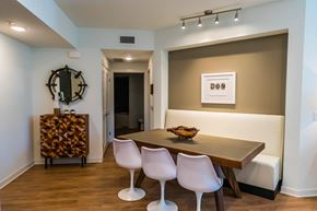 Costa Mesa apartment for rent - A dining room with a wooden table and white chairs. at Baker Block, California