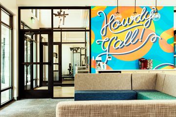 Austin apartment for rent - a living room with a couch and a large mural on the wall