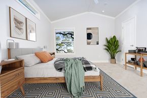 San Marcos apartment for rent - A bedroom with a bed, nightstand, and a window with a view of trees.