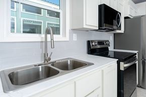 San Marcos apartment for rent - A modern kitchen with a double sink and stainless steel appliances.