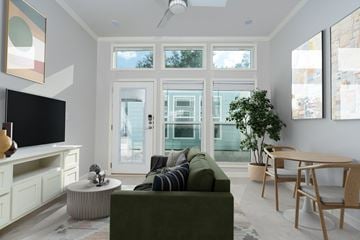 San Marcos apartment for rent - A living room with a green couch and a television.
