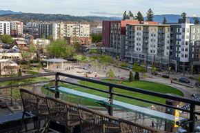 Redmond townhouse for rent - A view of a city from a balcony with buildings and a green field.