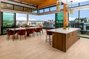 Redmond townhouse for rent - A modern kitchen with a long island and red chairs.