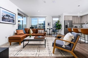 Redmond townhouse for rent - A living room with a brown sofa and a black coffee table.