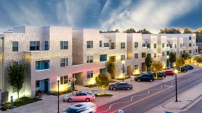 Oklahoma City apartment for rent - A modern apartment complex with cars parked in front.