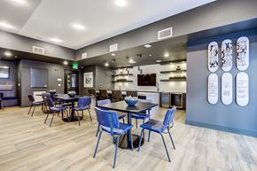 Oakland apartment for rent - a dining room with blue chairs and tables and a kitchen