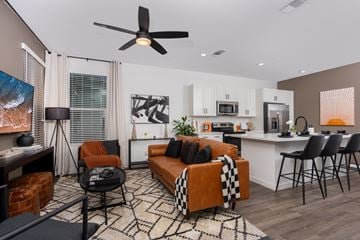 Lincoln apartment for rent - A living room with a brown couch and a black and white rug.