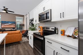 Lincoln apartment for rent - A modern kitchen with a black oven and white cabinets.