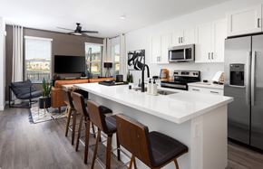 Lincoln apartment for rent - an open concept kitchen and living room with a large white island with a white countertop and