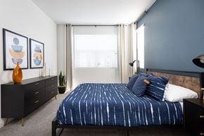 Lincoln apartment for rent - a bedroom with a bed and dresser in a 555 waverly unit