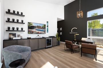 Mckinney apartment for rent - A modern living room with a grey sofa and a wooden floor.