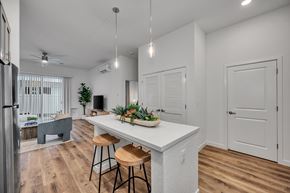 Roseville townhouse for rent - Open concept kitchen with white island and pendant lighting at Estia Roseville Apartments, California, 95747