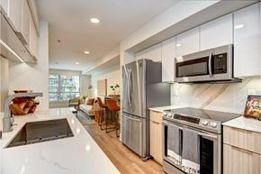 Seattle apartment for rent - Modern kitchen with marble backsplash and breakfast bar at Eastlake 2851 Apartments, Seattle, Washington