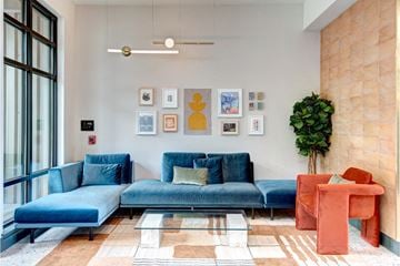 Seattle apartment for rent - A living room with a blue couch and a red chair.