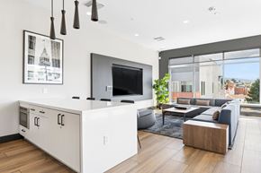 Oakland apartment for rent - A modern kitchen with a large island and a flat screen TV mounted above it.
