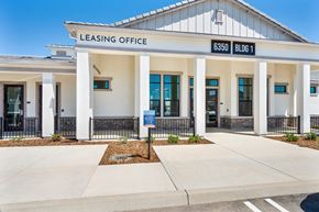 Roseville townhouse for rent - A white building with a sign that says Leasing Office.