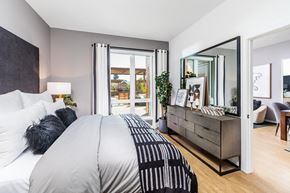 Sunnyvale apartment for rent - a bedroom with a large bed and a dresser with a mirror