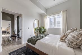 Sacramento apartment for rent - a bedroom with a bed and a large window