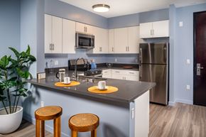 Los Angeles apartment for rent - A kitchen with a grey counter top and white cabinets.