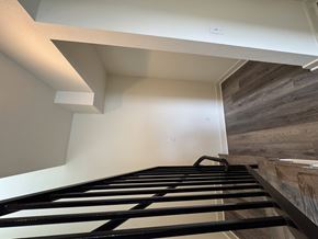 Corona townhouse for rent - A staircase with a metal railing and wooden steps.