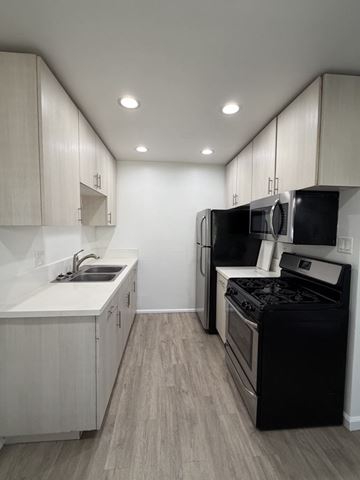Chula Vista apartment for rent - A kitchen with black appliances and white cabinets.