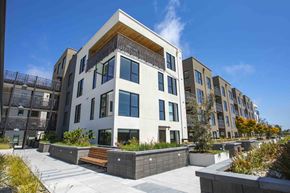 Berkeley apartment for rent - A modern apartment building with a courtyard in front.