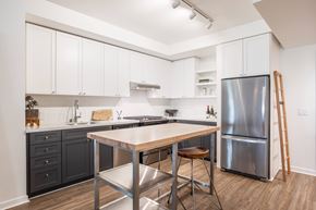 Berkeley apartment for rent - A kitchen with a table and chairs and a refrigerator.