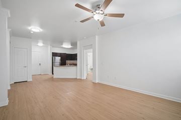 Fullerton apartment for rent - A room with a ceiling fan and wooden flooring.