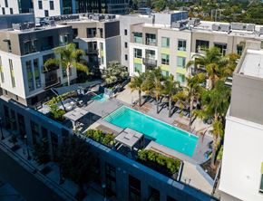 Sunnyvale apartment for rent - an aerial view of a swimming pool in front of a building