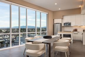 Sunnyvale apartment for rent - A modern kitchen with a dining table and chairs in front of large windows overlooking a cityscape.