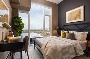 Sunnyvale apartment for rent - A bedroom with a large bed and a view of the city.