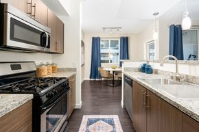 Henderson apartment for rent - a kitchen with stainless steel appliances and granite counter tops at Miro at the Parc, Henderson