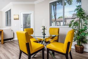 Chino Hills apartment for rent - Two Bedroom Apartments in Chino Hills, CA - Missions at Chino Hills - Dining Area Featuring Glass Table and Seating, High Ceilings with Crown Molding, Windows with Wood Shades