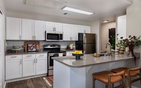 Napa apartment for rent - A kitchen with white cabinets and a grey countertop at Montrachet Apartments, Napa, CA
