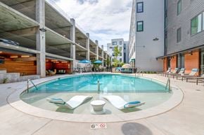 Oklahoma City apartment for rent - A round glass pool with four chairs around it.