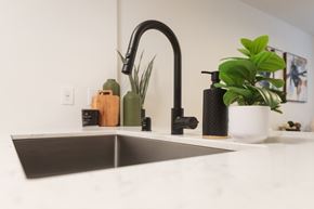 Seattle apartment for rent - Kitchen sink with black faucet and white countertop at Noda Apartments, Washington