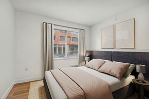 Seattle apartment for rent - Bedroom with upholstered headboard and window blinds at Noda Apartments, Washington