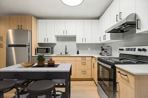 Seattle apartment for rent - A modern kitchen with wooden cabinets and stainless steel appliances.