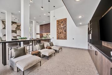 Oceanside apartment for rent - A modern living room with a large couch and a television.