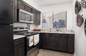 El Paso apartment for rent - A kitchen with black cabinets and appliances.