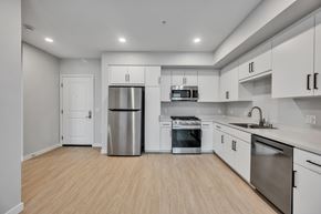 Ontario apartment for rent - A kitchen with white cabinets and stainless steel appliances.
