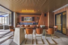 Las Vegas apartment for rent - A modern dining room with a wooden ceiling and brown chairs.