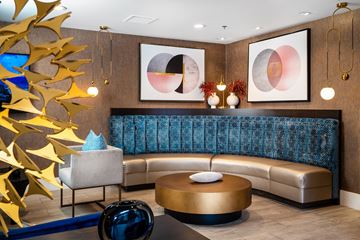 Los Angeles apartment for rent - A modern living room with a blue sofa and gold decorations.