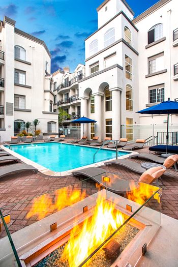 Community clubhouse with swimming pool and a firepit