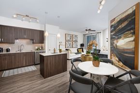 Irvine apartment for rent - A modern kitchen with brown cabinets and a white island.