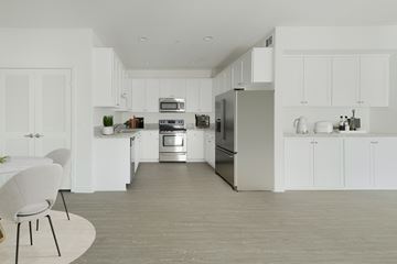 Los Angeles apartment for rent - A modern kitchen with white cabinets and stainless steel appliances.