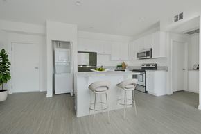 Los Angeles apartment for rent - A white kitchen with a bar and stools.at 422 South Lake, California, 90057