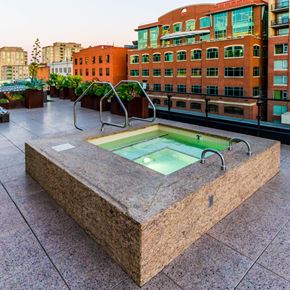 San Francisco apartment for rent - A hot tub on a rooftop patio surrounded by buildings.at Arc Light, San Francisco, CA