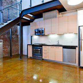 San Francisco apartment for rent - A kitchen with a stainless steel refrigerator and a black countertop.at Arc Light, San Francisco, CA 94107